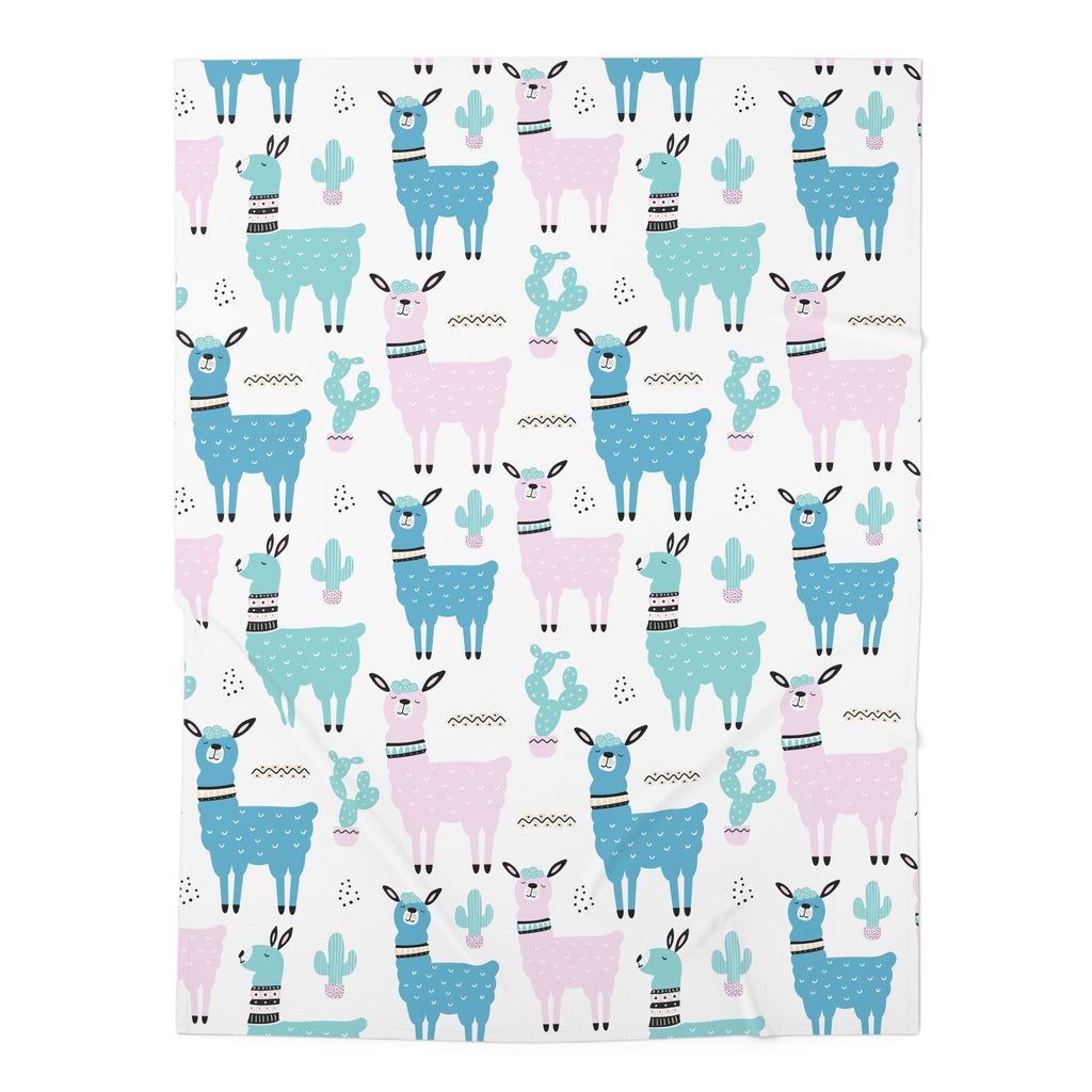 A square fabric item, likely a blanket or towel, featuring a repeating pattern of cartoon llamas and cacti in shades of blue, pink, and teal on a white background.